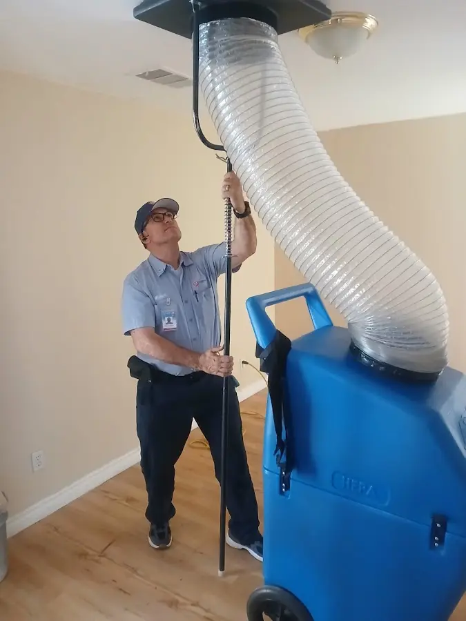 Furnace Tune-Up technician using HEPA equipment in Hewitt